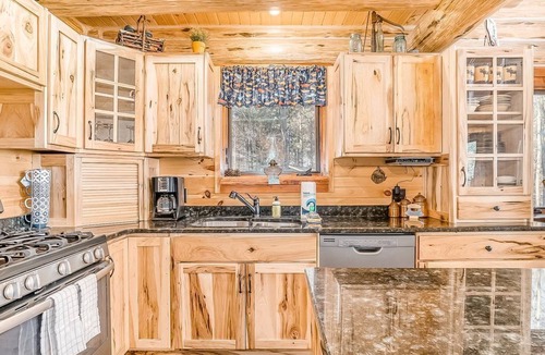 Thompsonville Cabin | Delightful Riverfront Cabin with Wood-Burning Fireplace and Gas Grill & Hot Tub