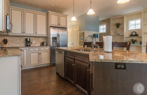 Saugatuck Condo | Discover comfort in Saugatuck at Lake Street Townhome #7, a 3BR retreat with pool views.