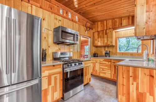 Zigzag House | Rustic lodge with private hot tub fireplace & riverfront views - dog-friendly