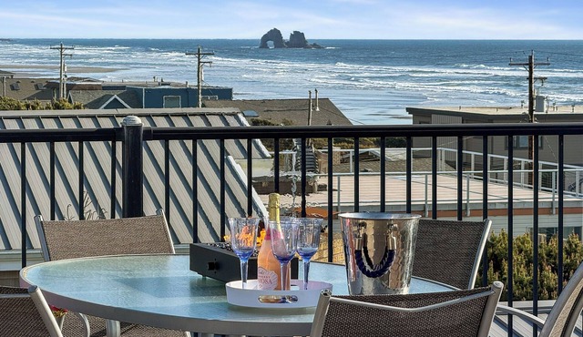 Panoramic ocean, lake, and mountain views surround this spacious 4-bedroom retreat. Enjoy a rooftop deck, game room, and easy beach access just steps from the sand.