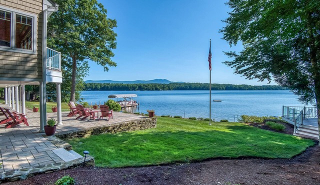 Stunning lakefront property with beach access, a dock, spacious yard, & W/D